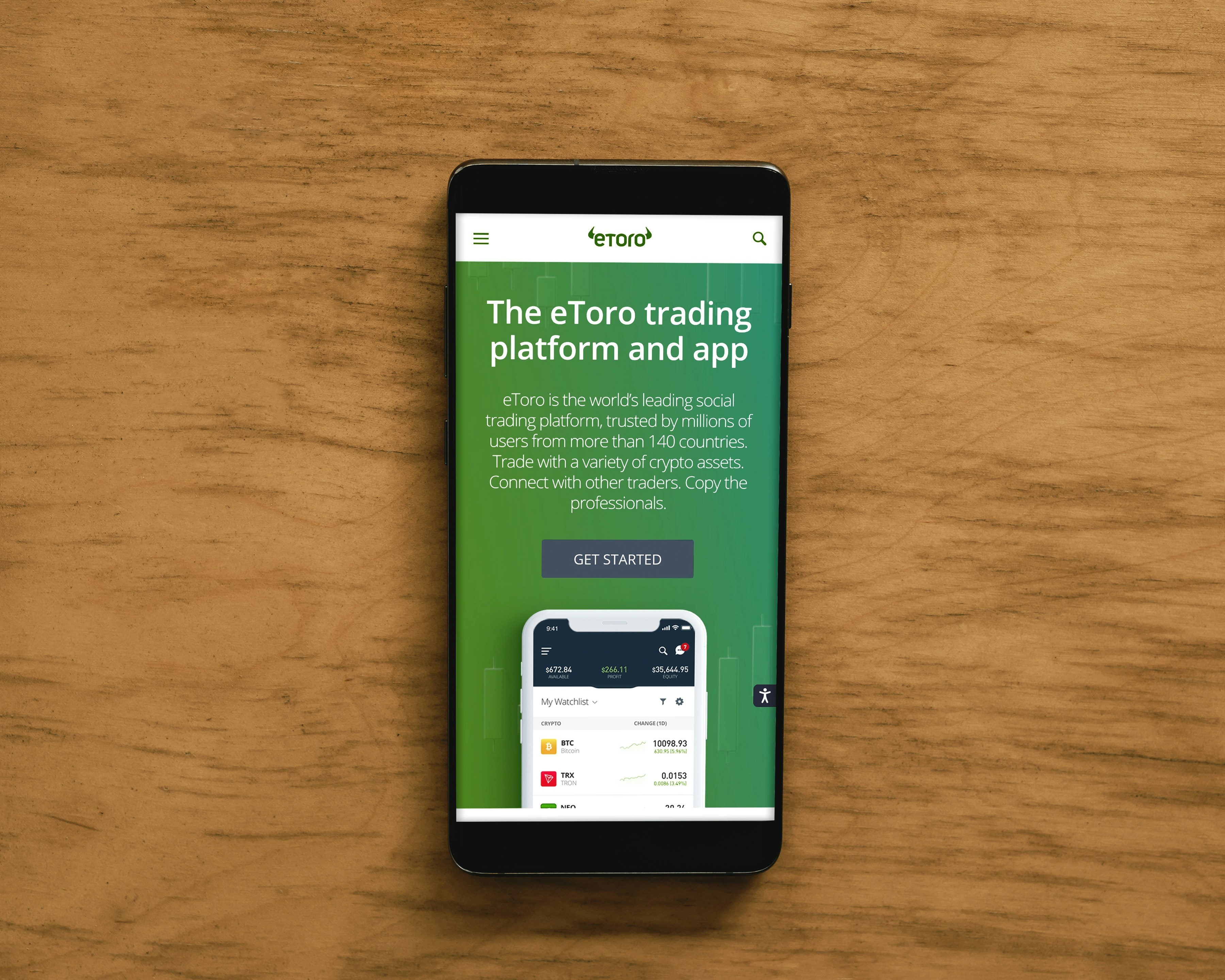 A smartphone displaying an advertisement for an online trading platform called eToro. The screen shows a green background with text promoting the platform as a leading social trading platform. A button labeled 'Get Started' is visible, along with a partial view of a mobile app screen below.